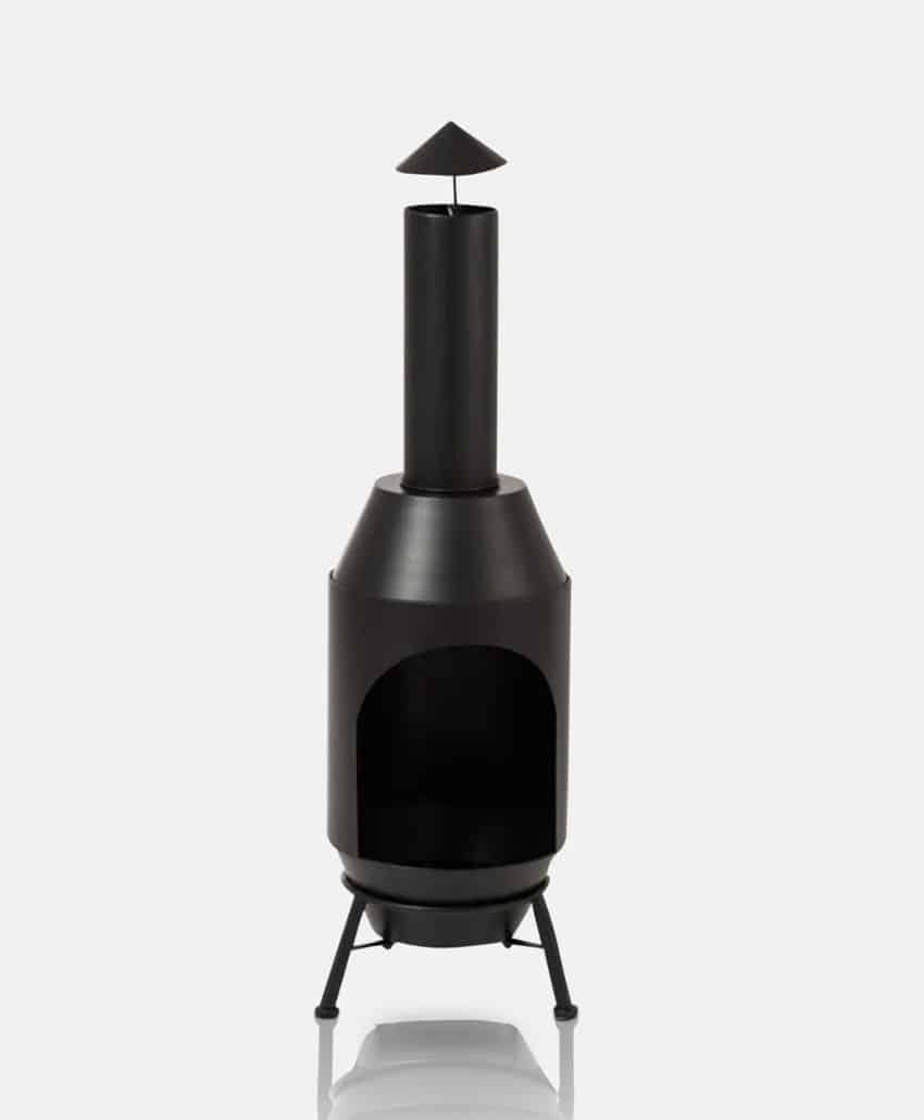 A black freestanding metal outdoor fireplace with a cylindrical chimney, conical top, and tripod legs, standing on a white background.