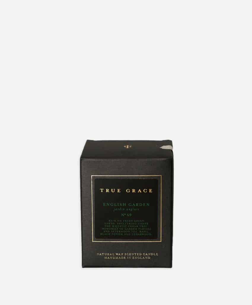 A black box with gold and green labeling for a True Grace English Garden scented candle, featuring text about the product and its natural wax, handmade in England.