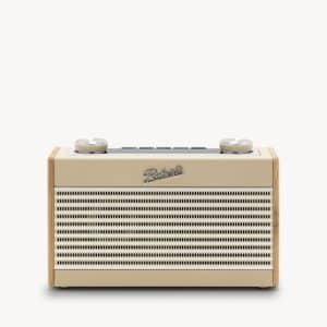 A cream and wood retro-style radio with two dials on top, a horizontal speaker grill, and the word Revival on the front, set against a plain white background.