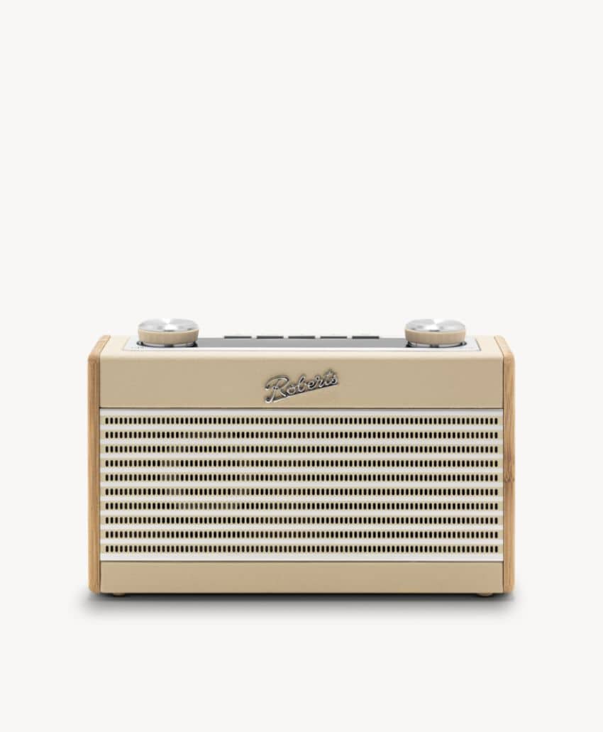 A cream and wood retro-style radio with two dials on top, a horizontal speaker grill, and the word Revival on the front, set against a plain white background.