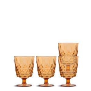 Four amber-colored, patterned glass goblets are shown, three stacked inside each other on the right and one standing alone on the left, all with short stems and wide bowls against a white background.