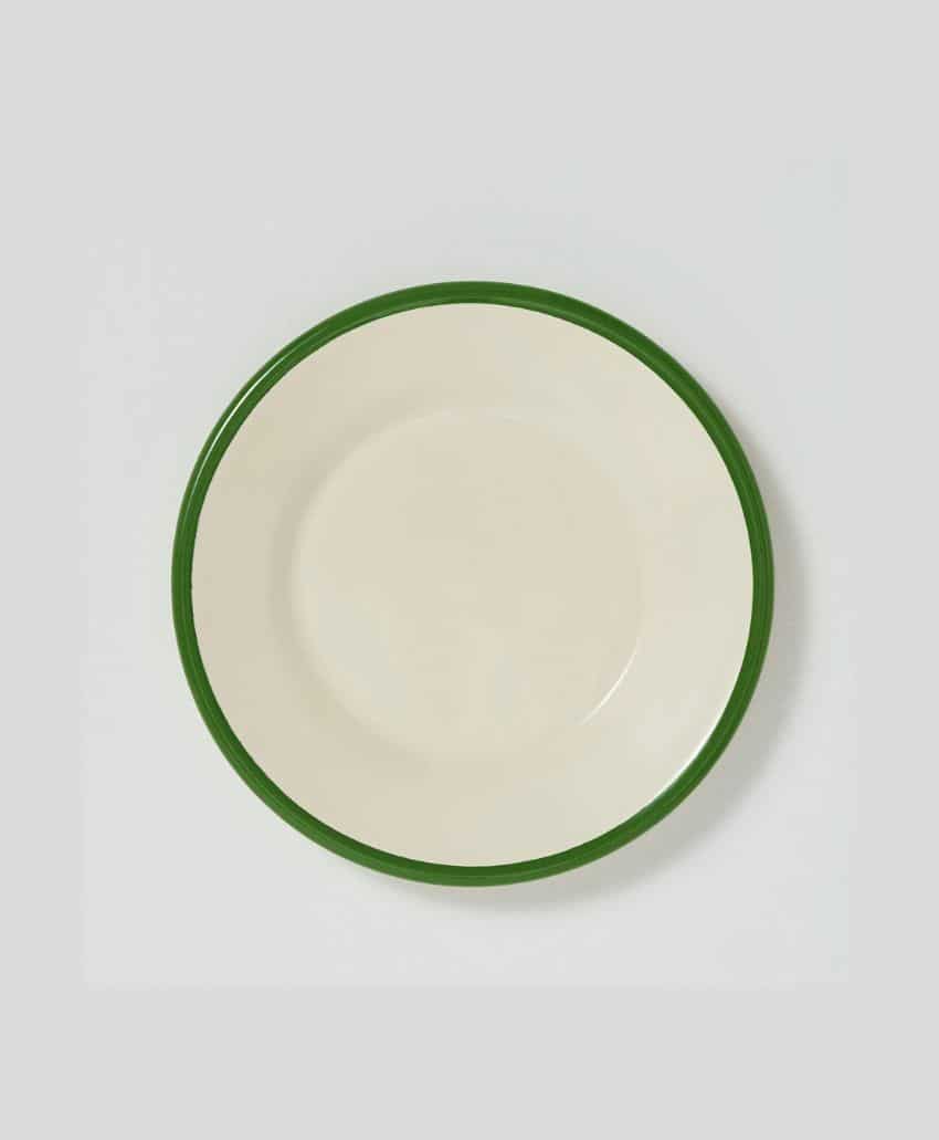 A plain white plate with a green rim, centered on a light gray background.