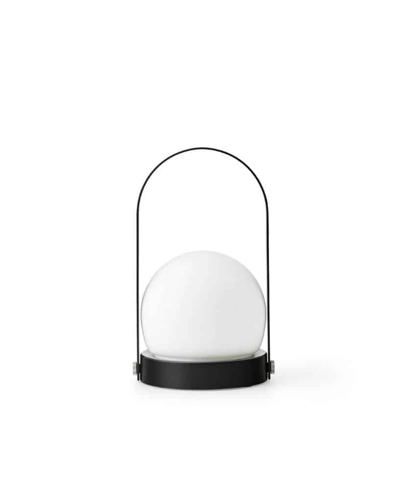 A modern portable lamp featuring a frosted white spherical light on a round black base, with a thin black handle arching over the top. The background is plain white.