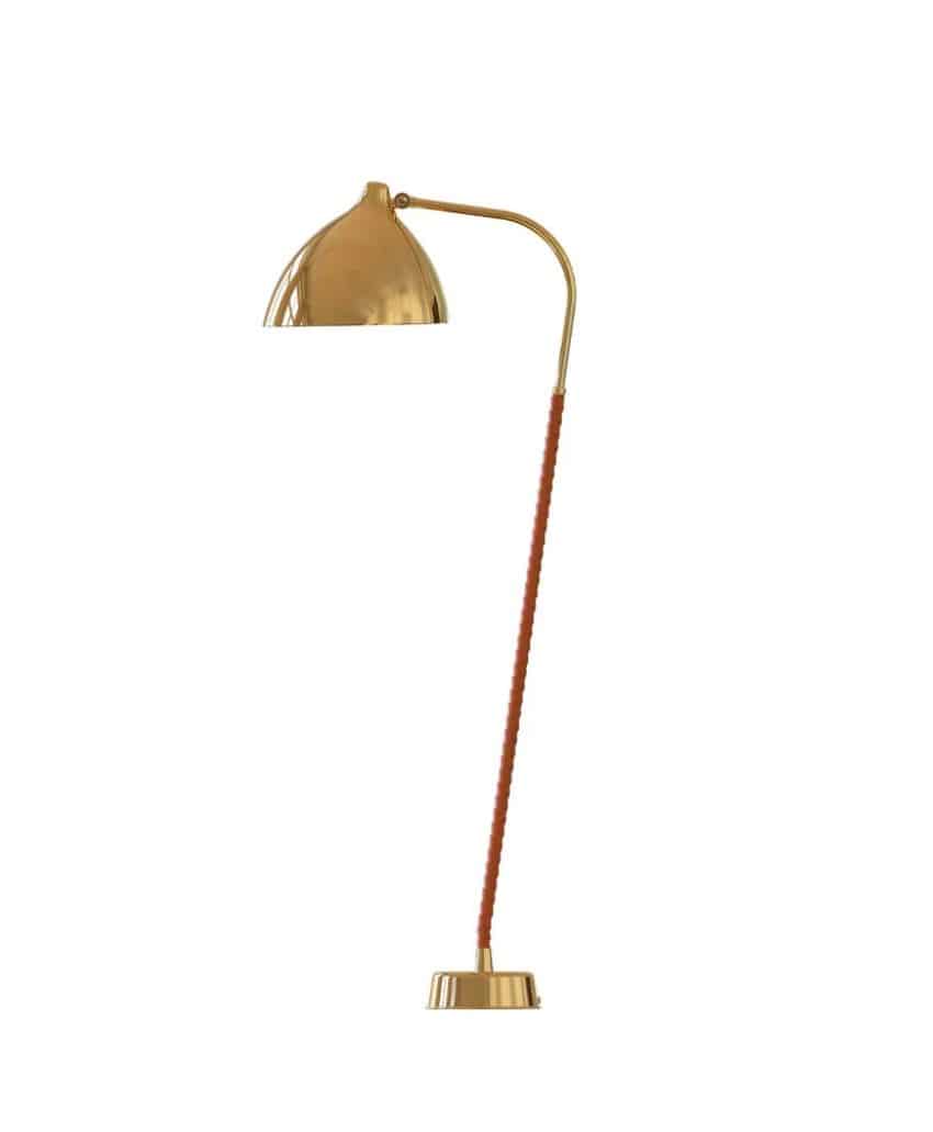A modern gold floor lamp with a curved arm, dome-shaped shade, and a slim, partially brown-covered stand on a round base, set against a white background.