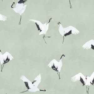 Illustrated white cranes with black wing tips and red crowns are shown flying and standing on a soft, pale green background in a repeating pattern.