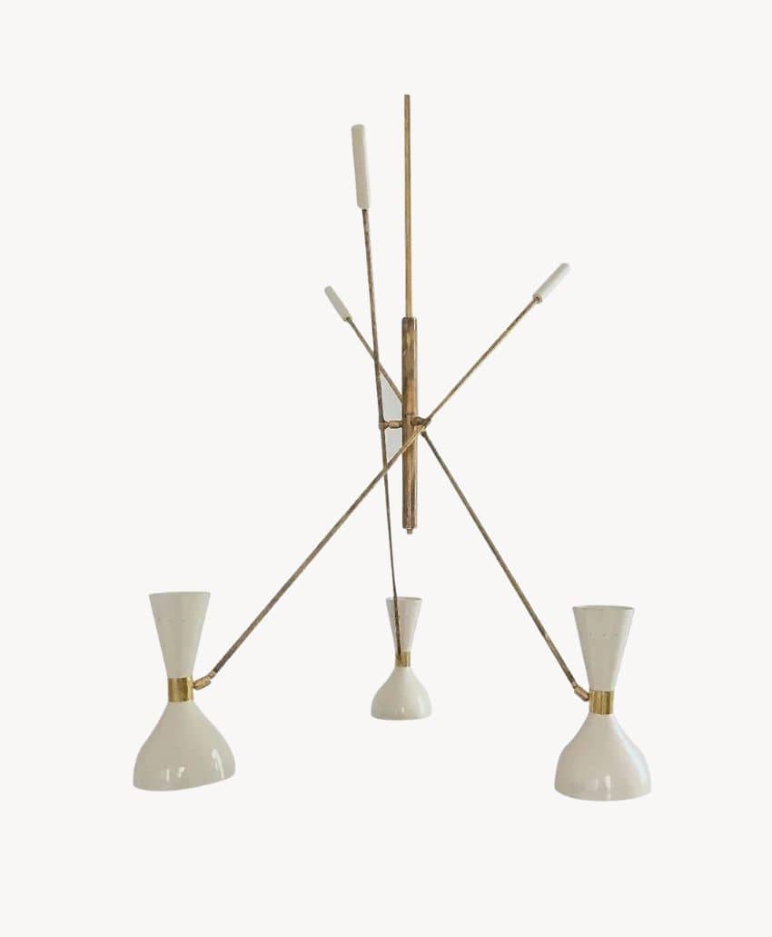 A modern, three-arm brass chandelier with white, cone-shaped lampshades, each extending outward at an angle from a central vertical rod.