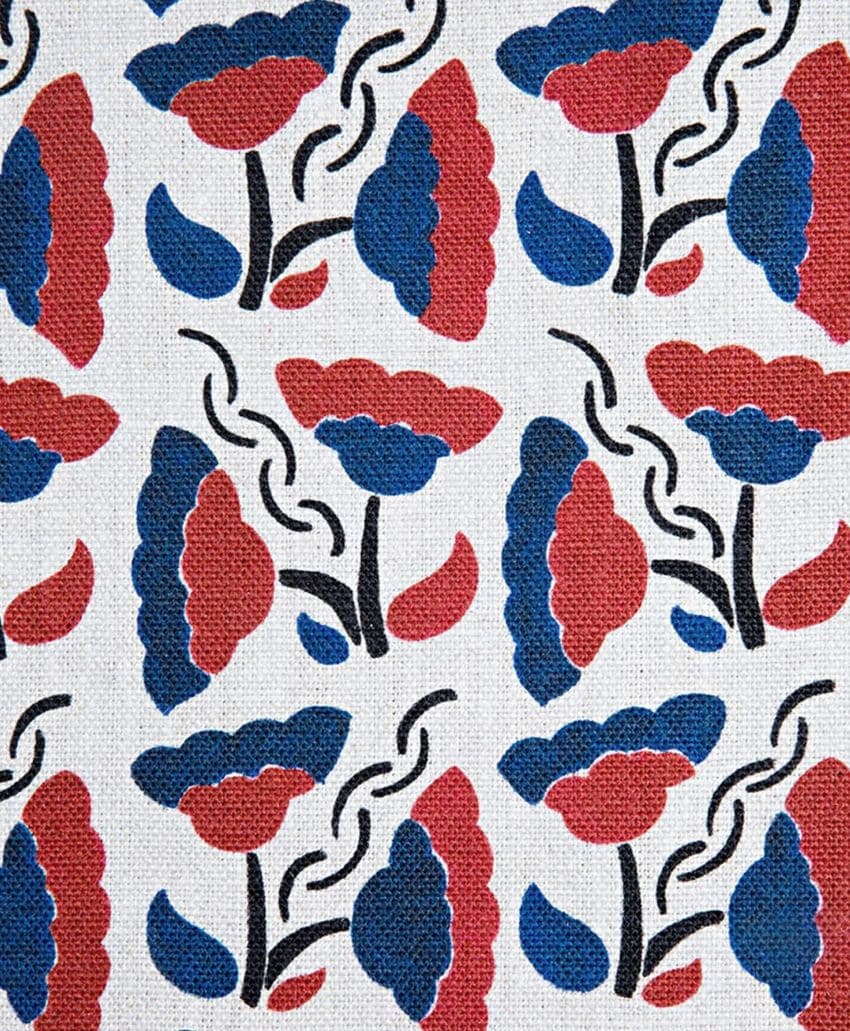 Patterned fabric with a repeating design of stylized red and blue flowers with black stems and leaves on a white textured background. The flowers appear in alternating directions, creating a symmetrical, decorative motif.