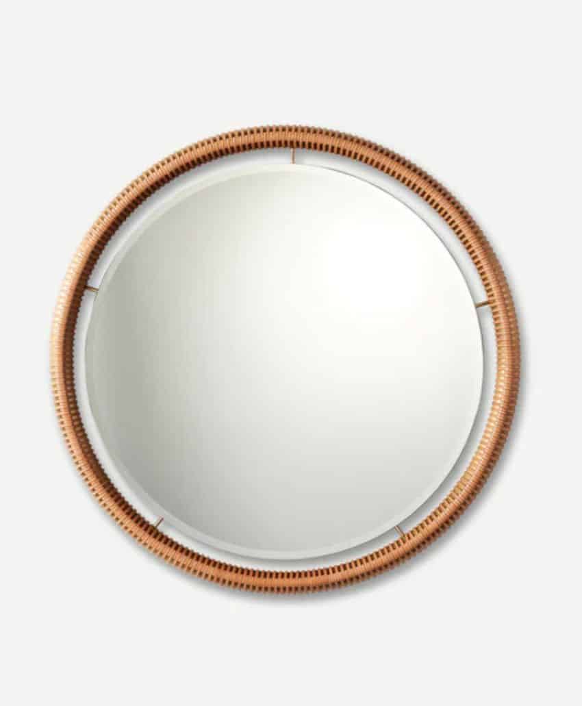 A round mirror with a light brown, woven rattan frame, viewed from the front against a plain light gray background.