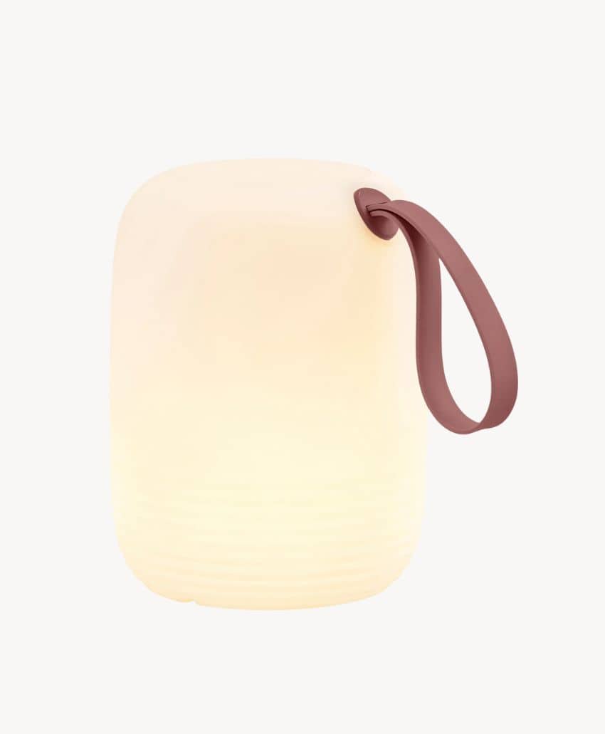 Softly glowing, rounded white lantern with a smooth surface and a curved, brown handle attached to the top, set against a plain white background.