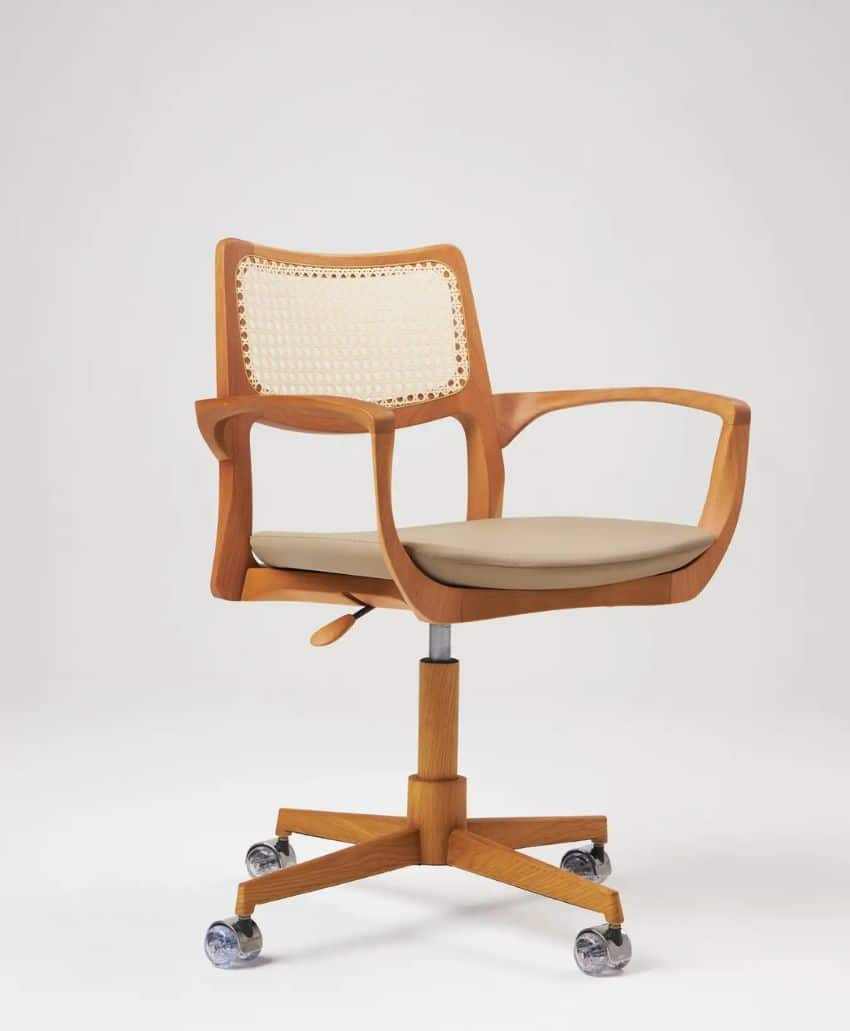 A wooden office chair with a beige cushioned seat, cane backrest, wooden armrests, and a five-wheel metal base, set against a plain white background.