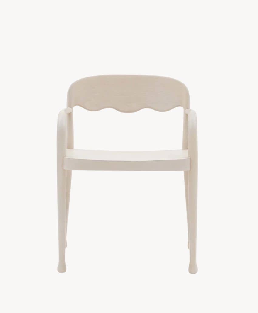 A light-colored wooden chair with curved armrests and a wavy backrest, photographed from the front against a plain white background.