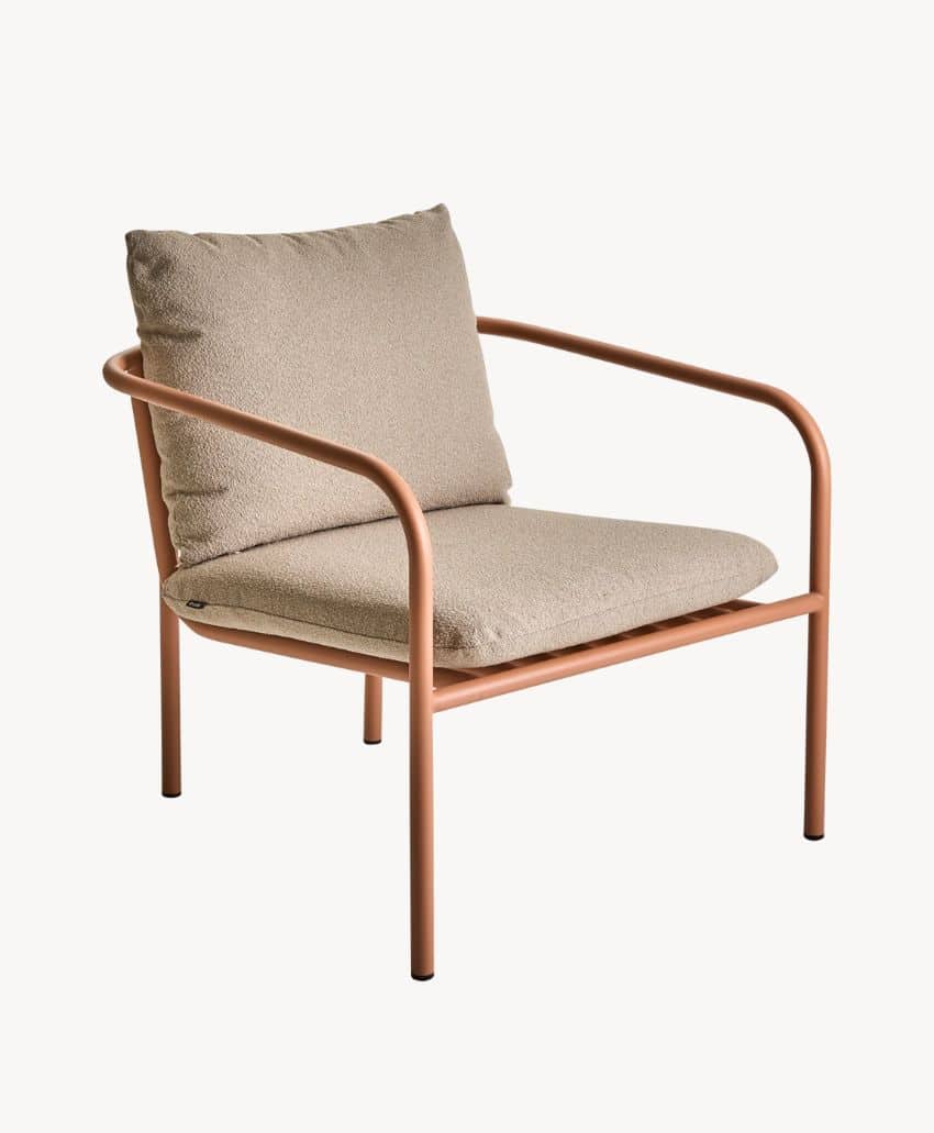 A modern lounge chair with a light brown metal frame, beige seat cushion, and matching beige back cushion, set against a plain white background.