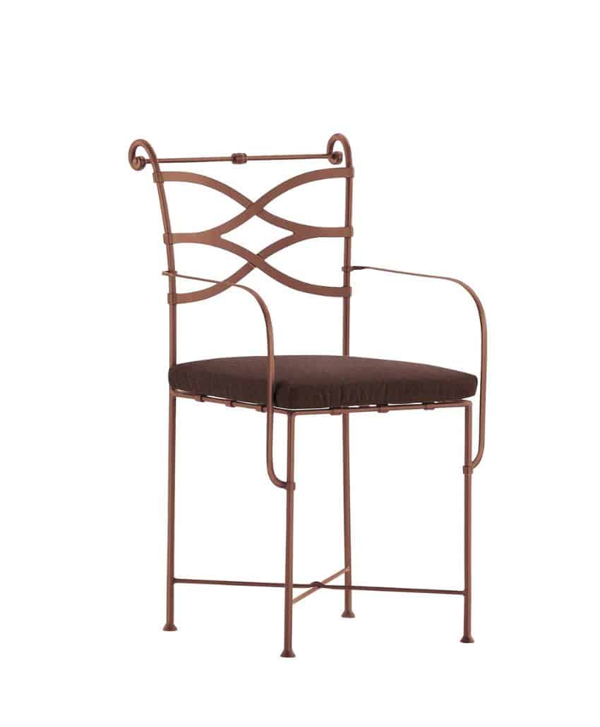 A metal chair with thin, brown frame, curved armrests, decorative crisscross backrest, and a dark padded seat cushion.