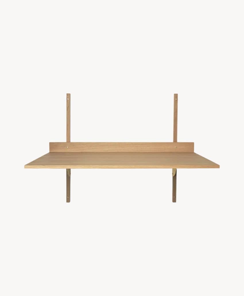 A minimalist wooden wall-mounted desk with two vertical supports and a horizontal surface, designed for compact spaces. The desk is light wood and set against a plain white background.