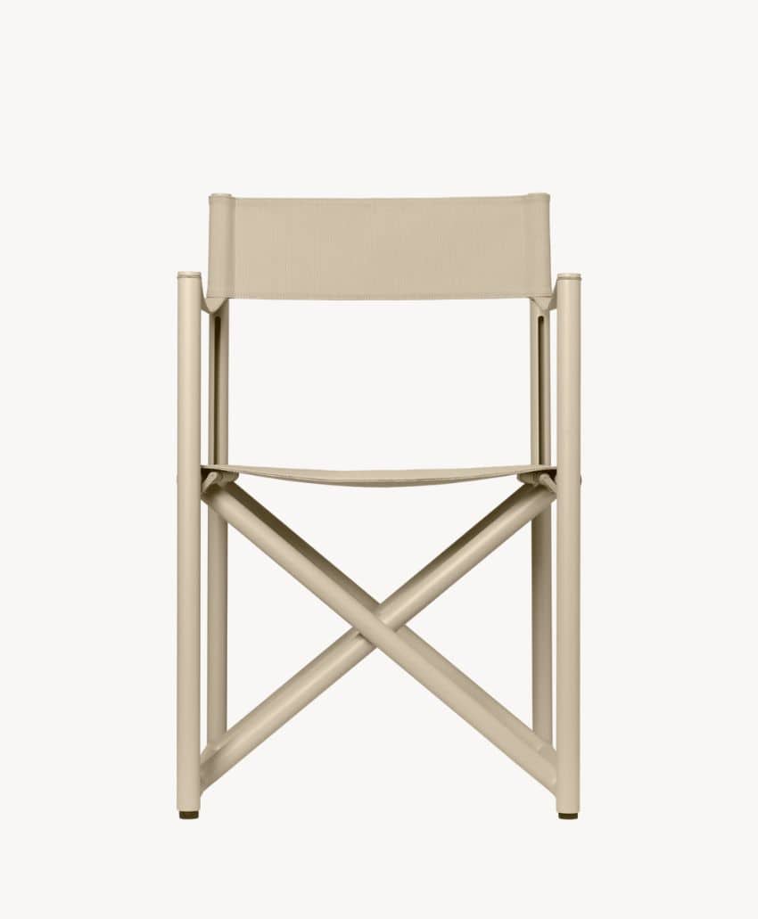 Front view of a modern, minimalist beige director’s chair with a canvas backrest and seat, and crossed metal legs. The background is plain white.