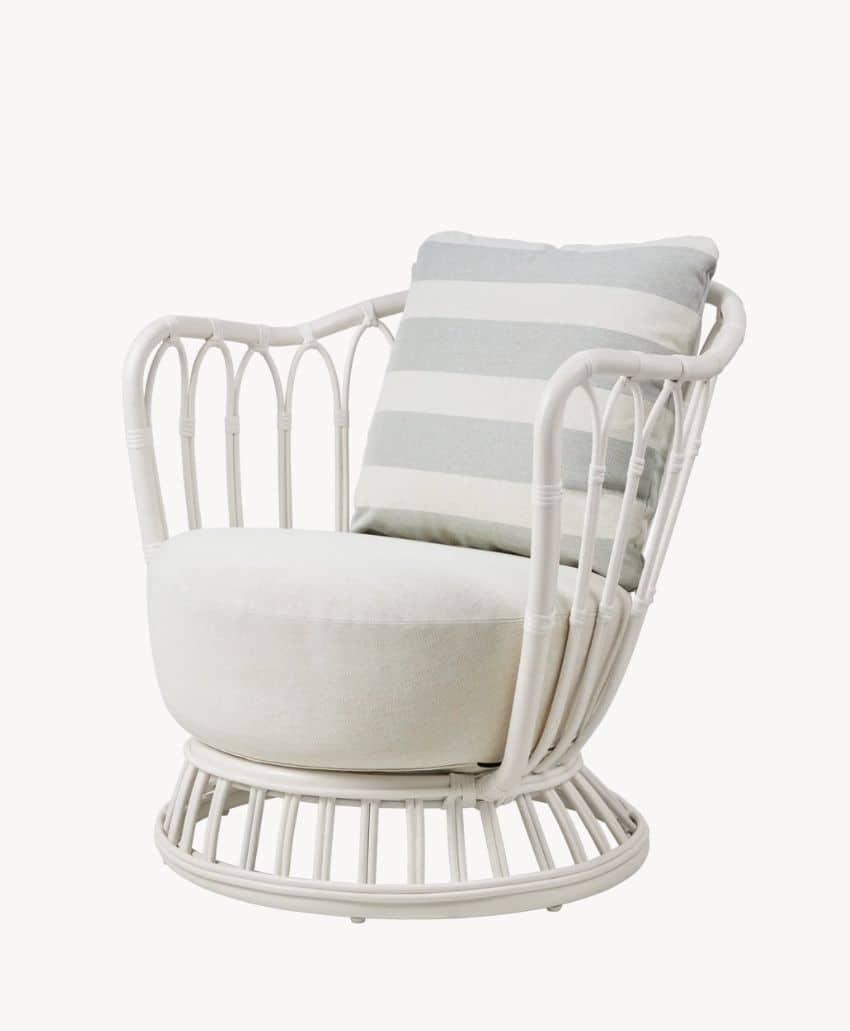 A modern rattan armchair with a white frame, round seat cushion, and a square pillow featuring wide gray and white horizontal stripes. The chair has an open, airy design and a circular base.