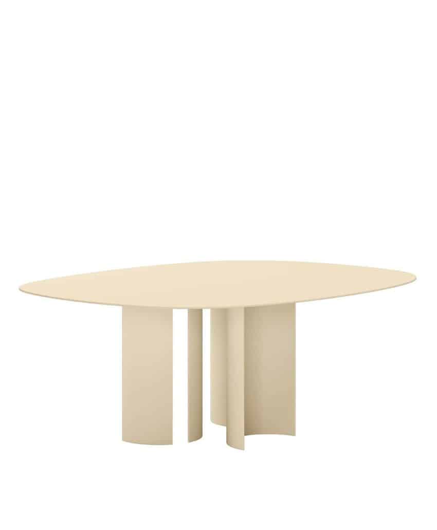 A modern, minimalist beige table with an oval top and four wide, curved pedestal legs arranged in an artistic, sculptural style.