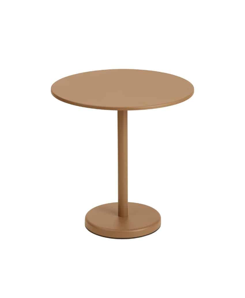 A round, light brown table with a single central pedestal base and a flat, circular top, set against a plain white background.