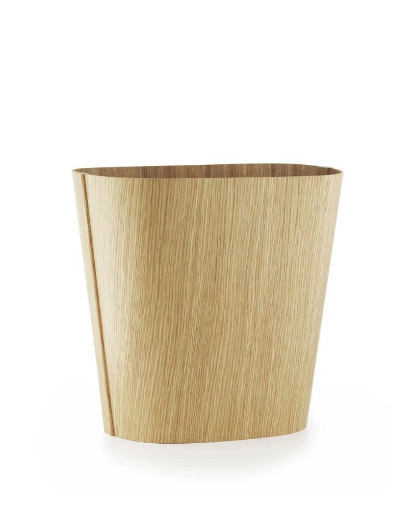 A modern, light wood wastebasket with a smooth, curved design and a natural grain finish, set against a plain white background.