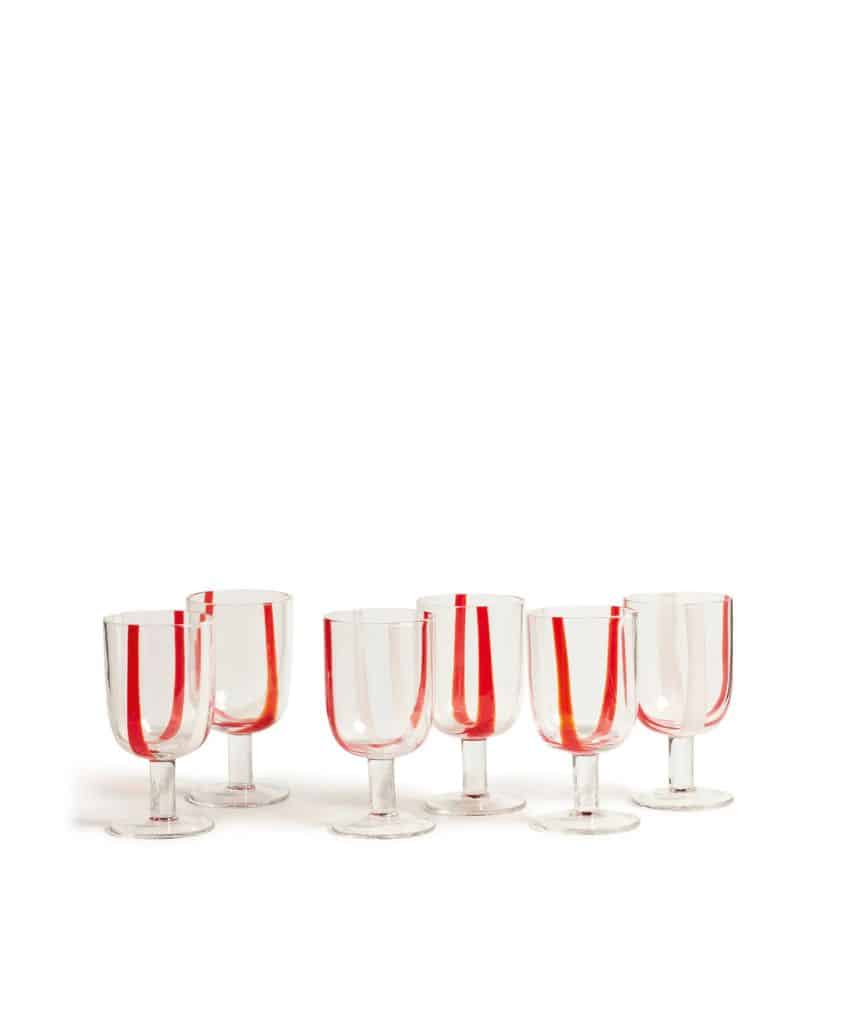 Six clear goblets with thick, vertical red stripes are arranged in two rows on a white background. The glasses have wide stems and a simple, modern design.