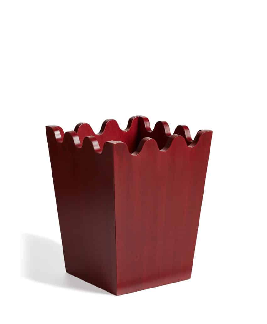 A dark red, square-shaped wooden container with wavy, scalloped edges, set against a plain white background.