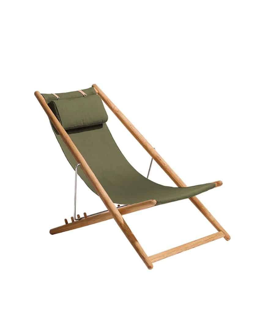 A foldable wooden deck chair with a green fabric seat and a matching headrest, isolated on a white background.