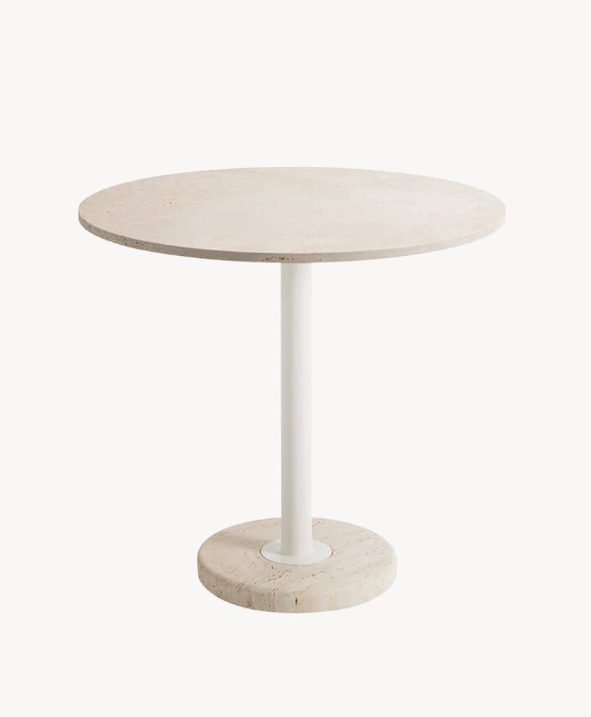 A round, light-colored table with a thick, stone top and base, supported by a single white cylindrical metal leg, on a plain white background.