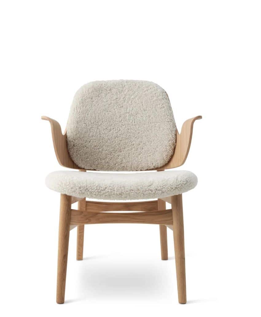 A wooden chair with light-colored, textured, upholstered seat and backrest. The chair has curved wooden armrests and a minimalist design against a white background.