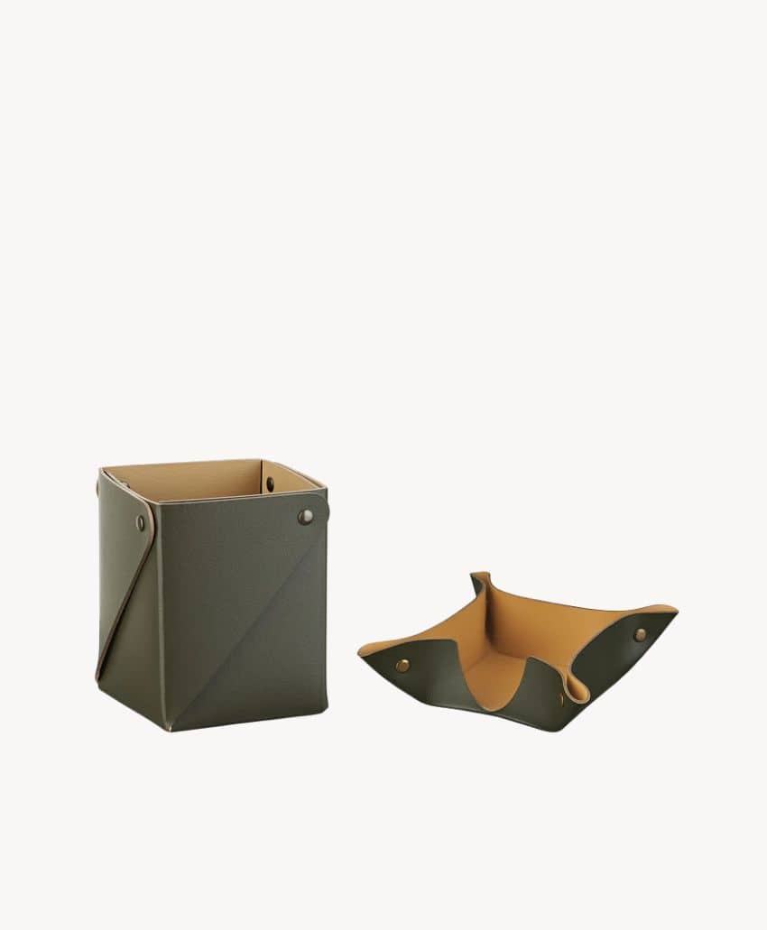Two olive green and tan leather desk organizers are shown. One is a standing rectangular container, and the other is a shallow tray with buttoned corners, both on a plain white background.