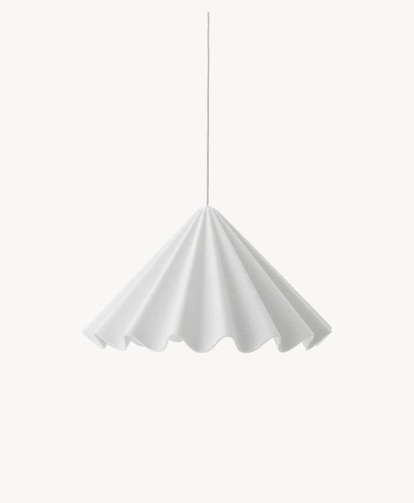 A white, pendant light fixture with a wavy, pleated lampshade resembling a ruffled fabric, hanging from a thin cord against a plain white background.
