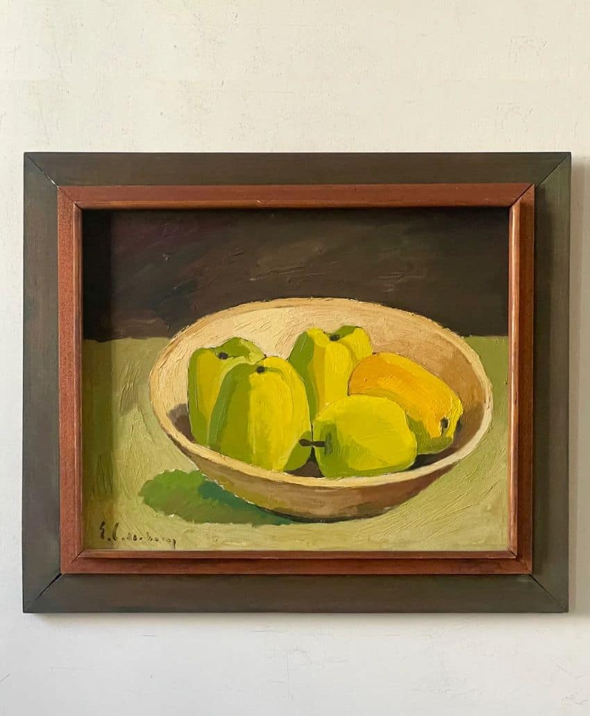 A framed painting of a bowl containing green bell peppers and a yellow lemon, set against a green and dark background. The artwork has a simple, still life style.