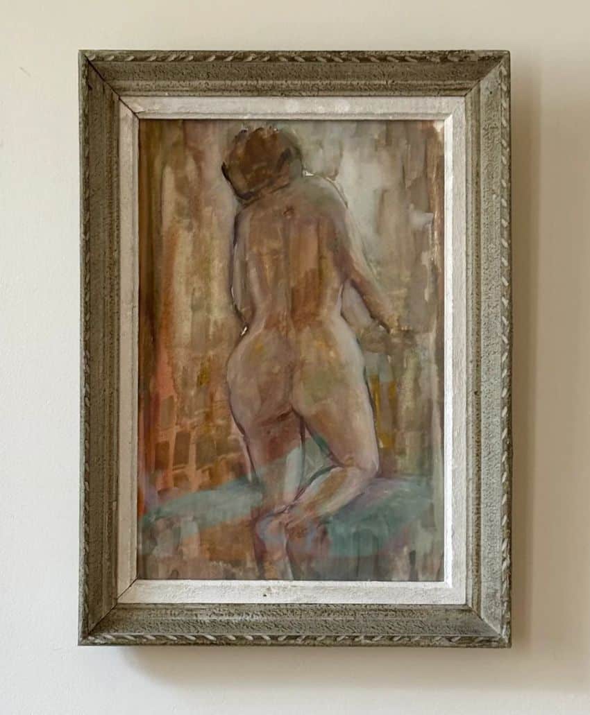 A framed painting of a nude figure seen from behind, kneeling with one leg raised. The background is abstract with muted earth tones and soft brushstrokes. The frame is rustic wood with a white inner border.
