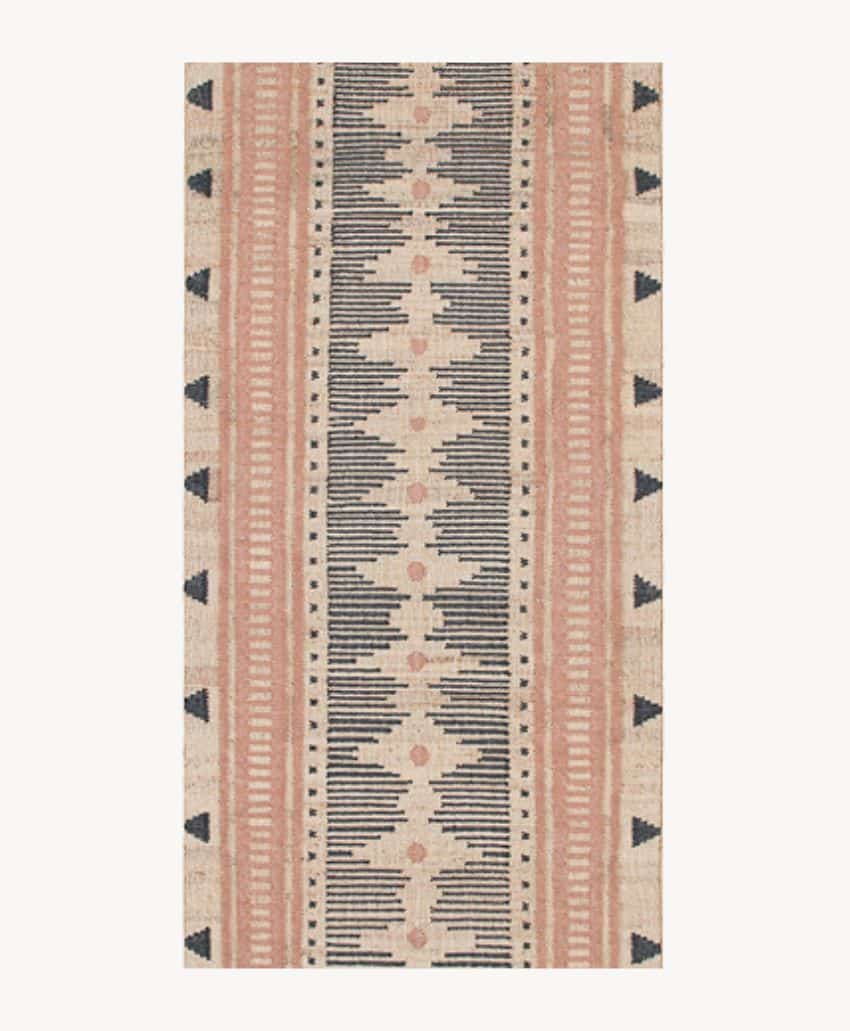 Rectangular rug with a geometric pattern in black, beige, and peach tones, featuring vertical stripes, small triangles on the sides, and symmetrical lines and dot motifs along the center.