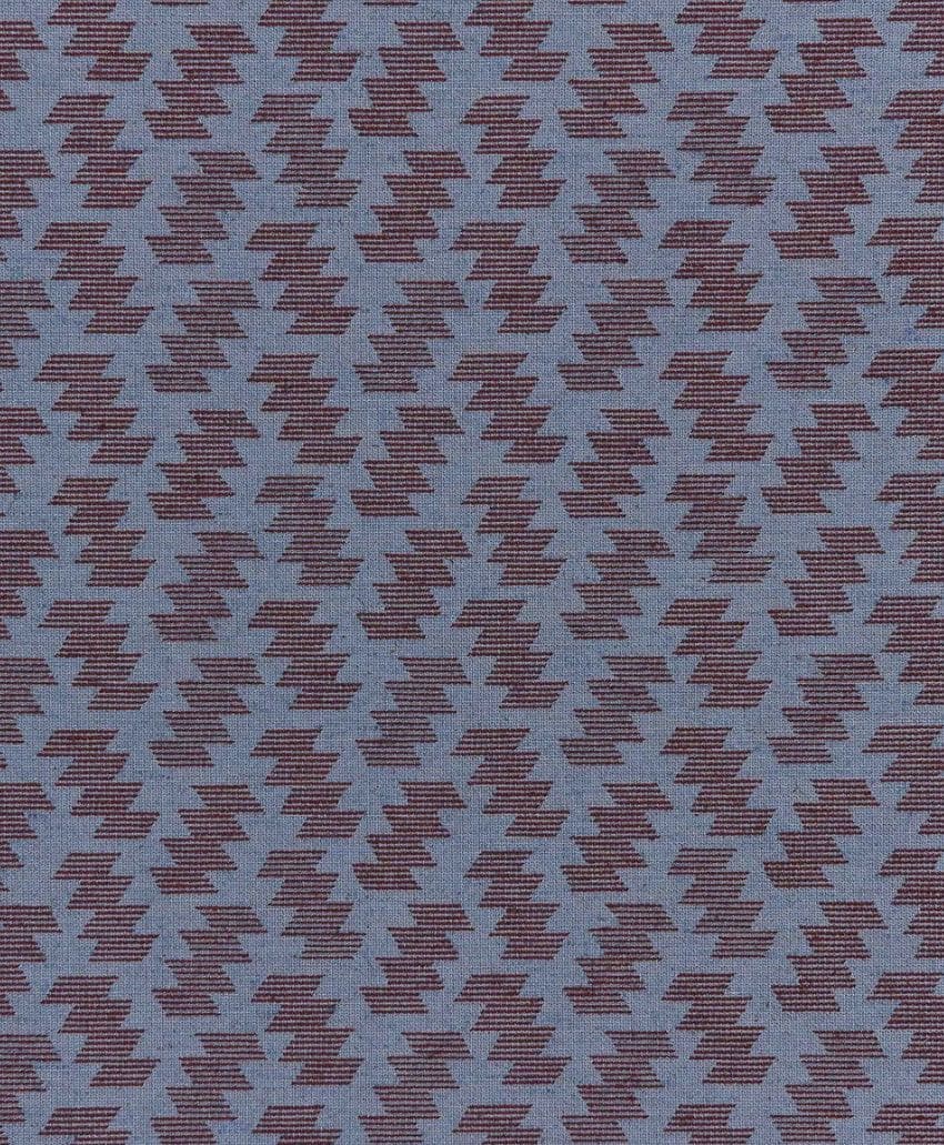 A repeating pattern of dark maroon zigzag shapes on a muted blue fabric background, creating a geometric, textured appearance.