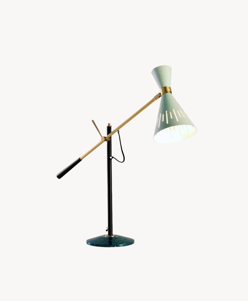 A modern desk lamp with a green base, black vertical stand, gold adjustable arm, and a green conical shade with white cutouts, set against a plain white background.