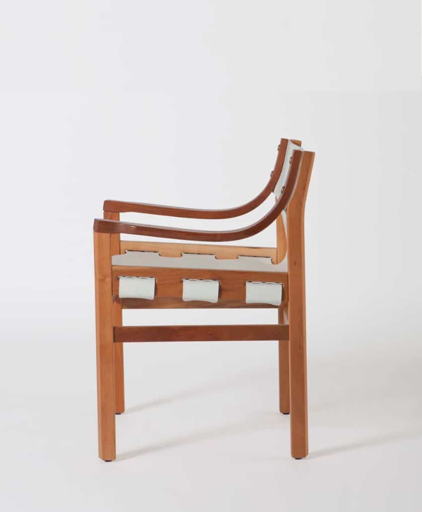 A modern wooden chair with curved armrests and a light-colored seat made of interwoven straps, photographed from the side against a plain white background.