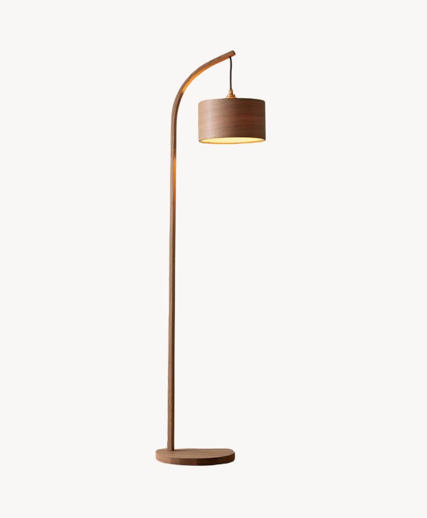 A modern wooden floor lamp with a round base, a tall, gently curved stand, and a cylindrical lampshade, all in a matching wood finish, against a plain white background.