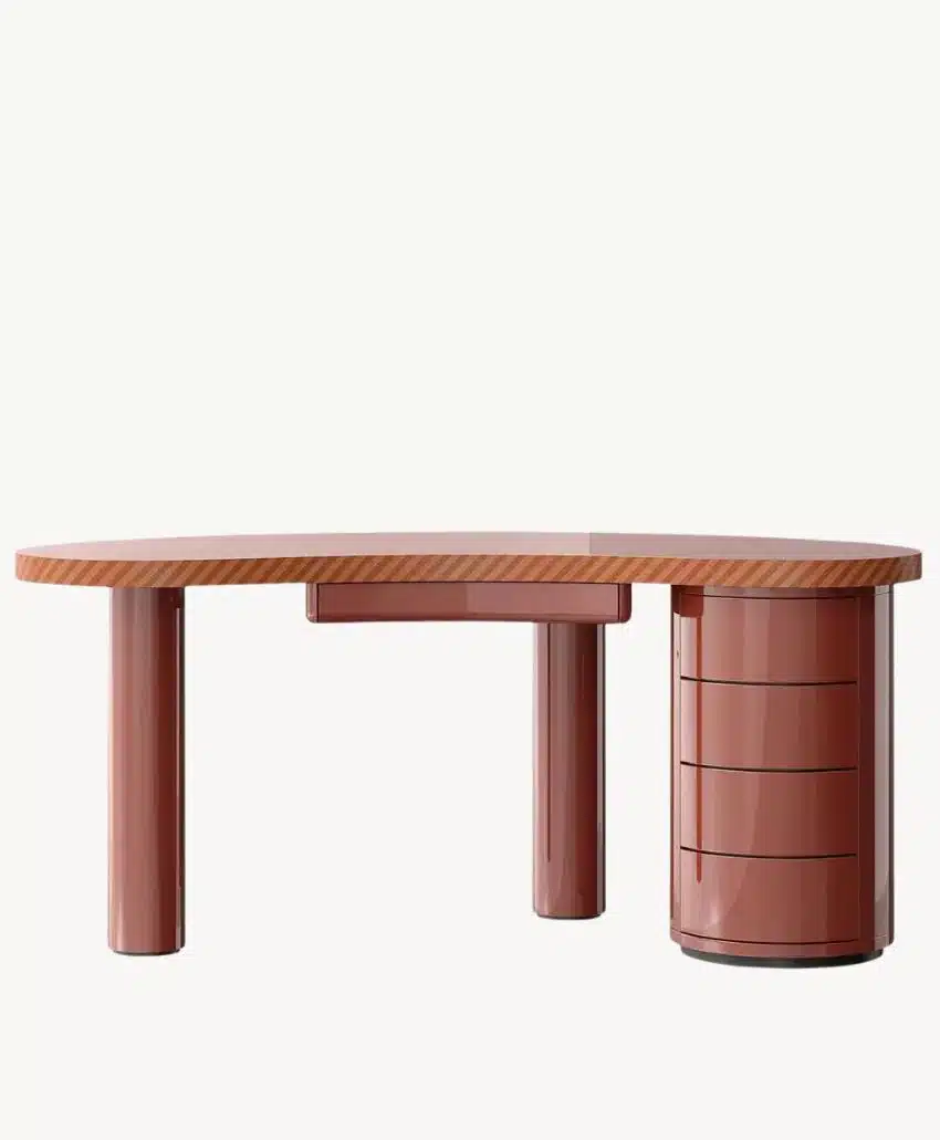 A modern, glossy, rust-colored desk with rounded corners, thick cylindrical legs, and a built-in set of four curved drawers on one side. The background is plain white.