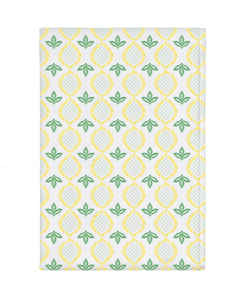 A white rectangular object features a repeating pattern of yellow pineapples with green leaves, evenly spaced in rows and columns on the surface.