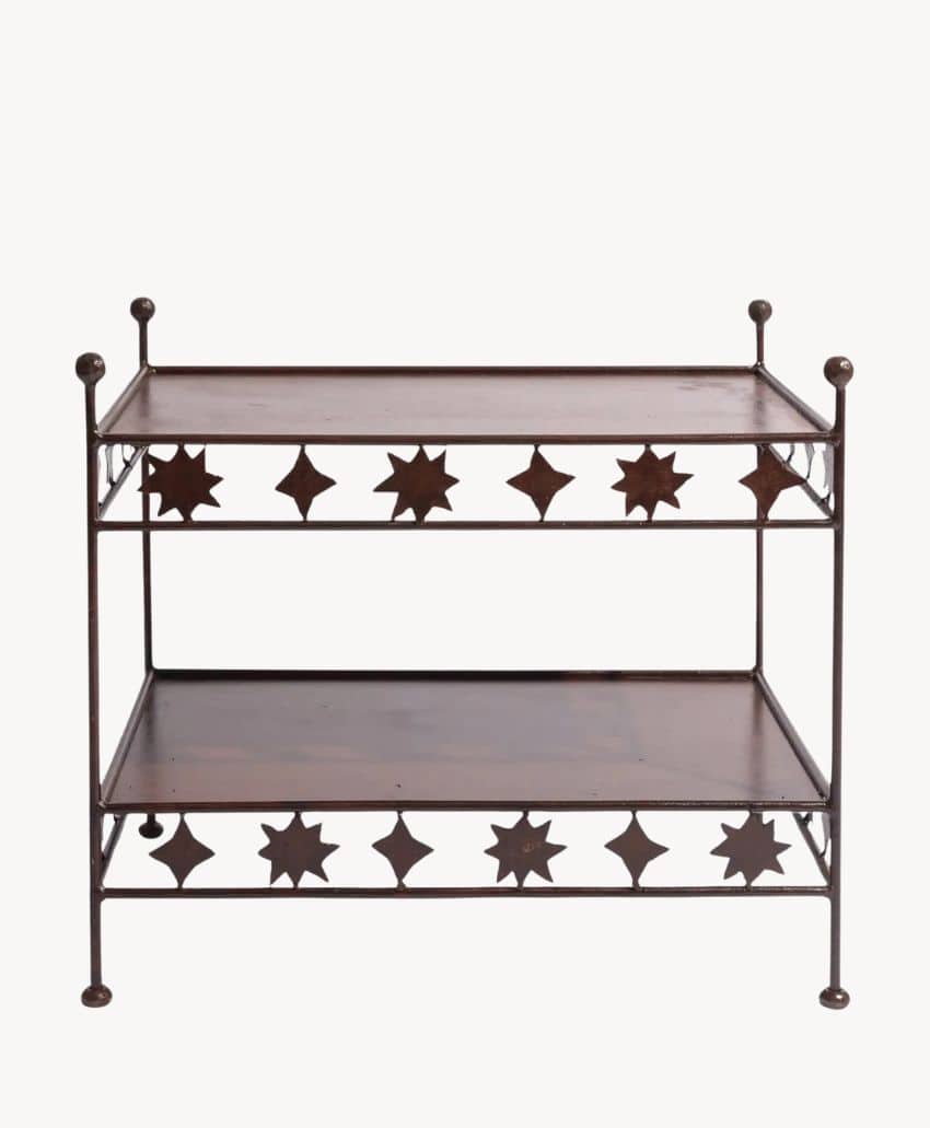 A two-tiered metal and wood console table with decorative star and diamond cutouts along the sides, featuring a dark finish and ball-capped corner posts.