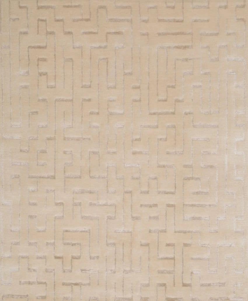 Beige carpet with a subtle, raised geometric maze-like pattern forming interconnected lines and right angles across the surface.
