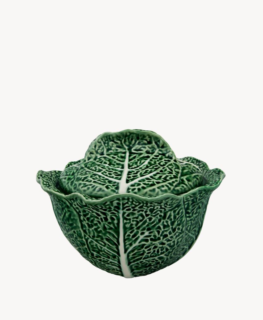 A ceramic bowl designed to look like a green cabbage, with detailed leaf textures and white veins, shown with its lid on against a plain white background.