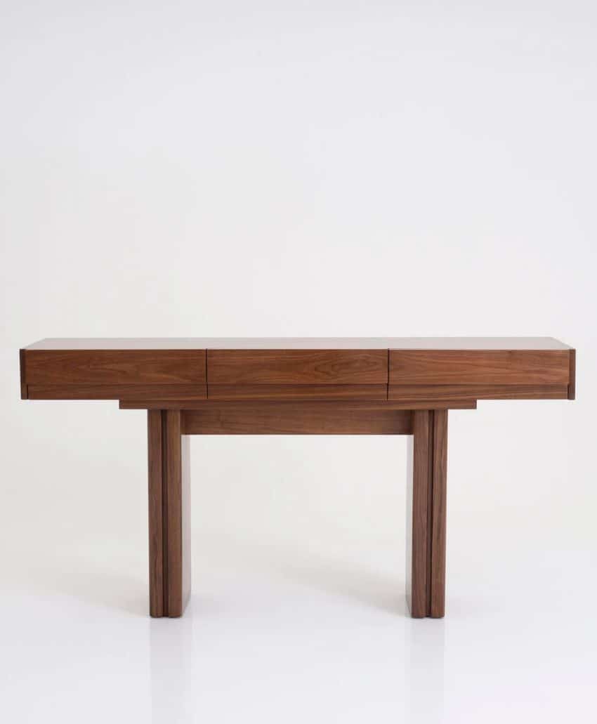 A modern, minimalist wooden console table with clean lines, three drawers, and two rectangular legs, set against a plain white background.