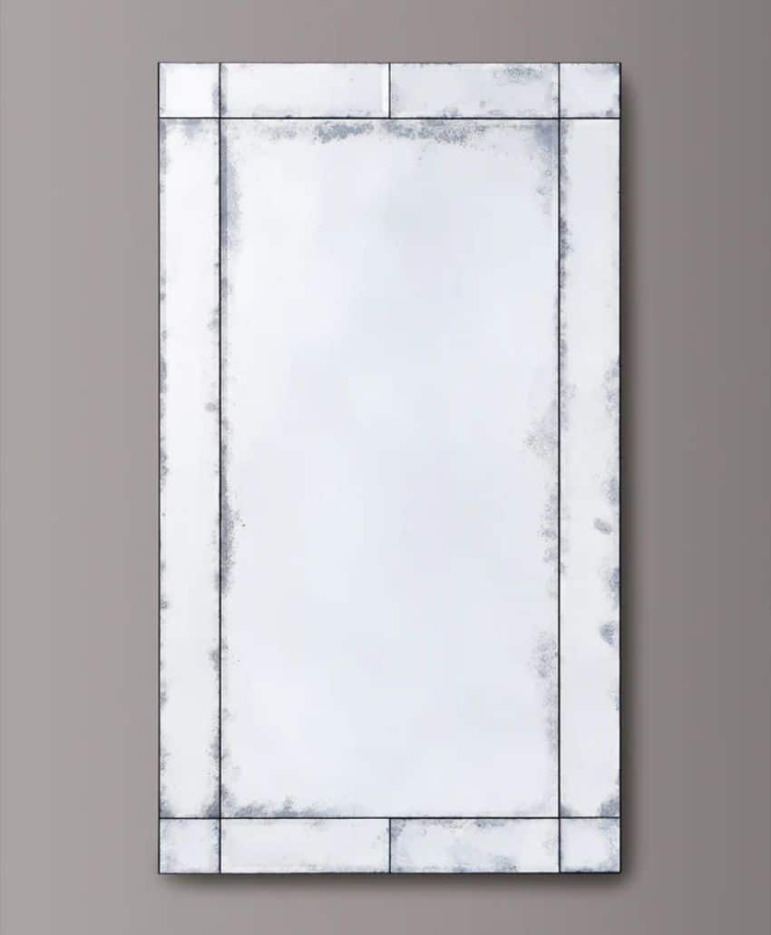 A large rectangular wall mirror with a beveled edge and a slightly distressed, antique-style frame, displayed against a plain gray background.