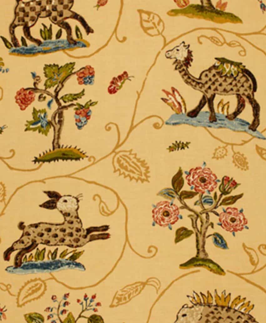 Whimsical fabric pattern featuring spotted deer, camels, and stylized trees with pink flowers on a light tan background, with winding vines and decorative leaves throughout.