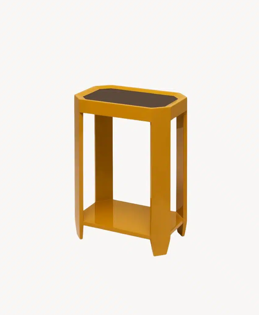 A small, yellow rectangular side table with four straight legs, an open lower shelf, and a dark tabletop surface, shown against a plain white background.