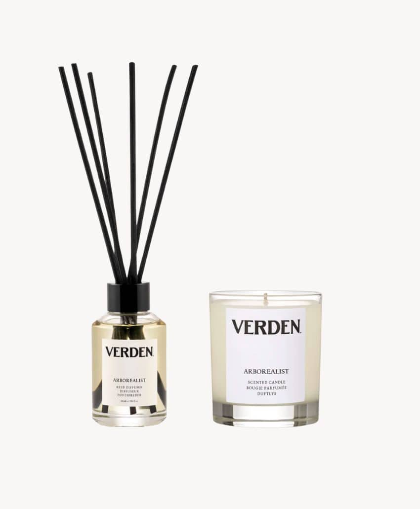 A glass reed diffuser with black reeds and a matching glass candle, both labeled VERDEN ARBOREALIST, are displayed against a plain white background.