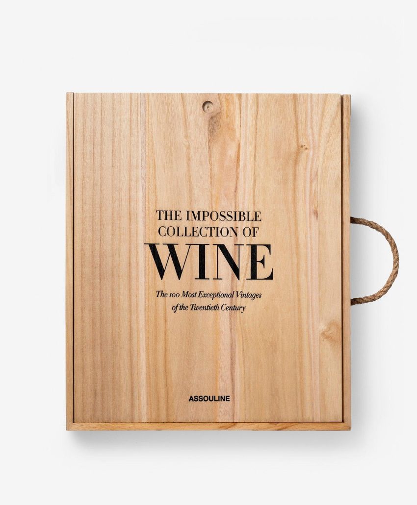 A wooden box with black text that reads: The Impossible Collection of Wine: The 100 Most Exceptional Vintages of the Twentieth Century. The box has a rope handle on the right side and the word Assouline at the bottom.