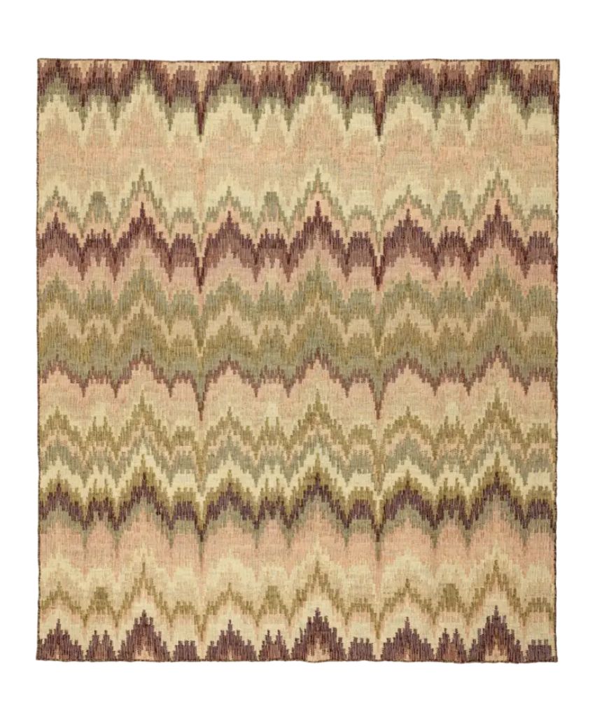 A square area rug with a zigzag or chevron pattern in muted tones of beige, olive green, brown, and tan, creating a wave-like effect across the surface.
