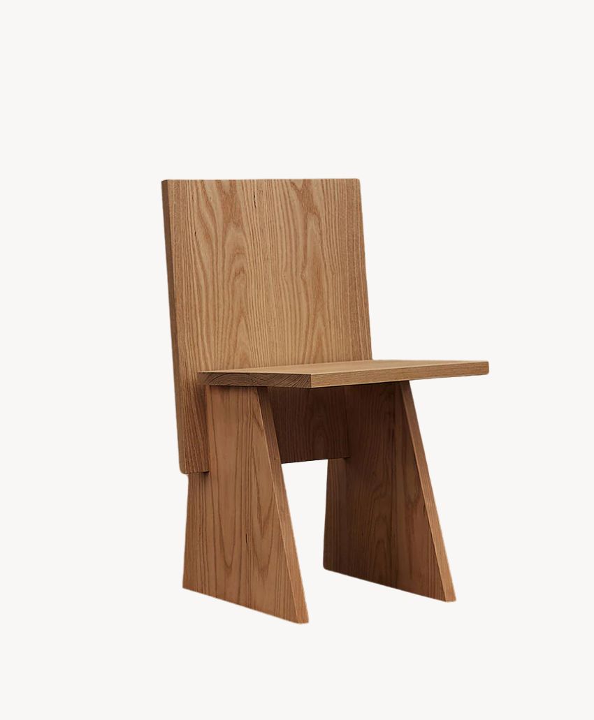 A wooden chair with a minimalist, geometric design featuring a flat seat, straight backrest, and angled side supports, all made from light-colored wood.